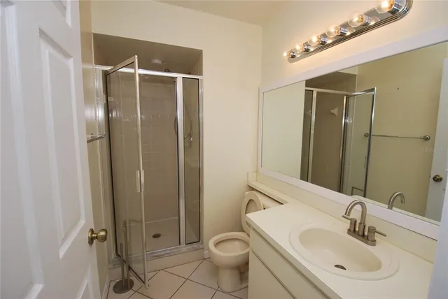an empty room with wooden floor and ceiling fan