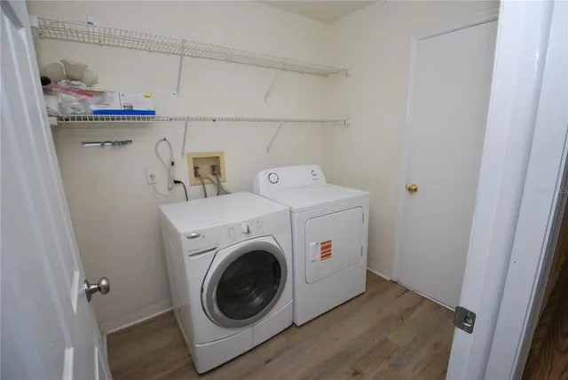 an aerial view of residential houses with outdoor space and ocean view