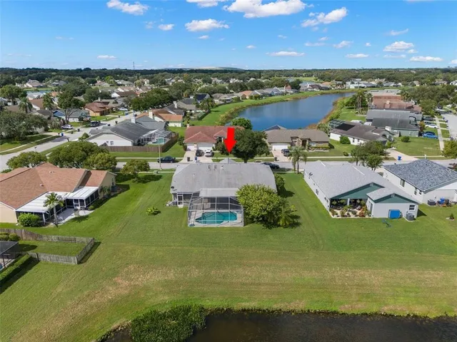 an aerial view of residential houses with outdoor space and river