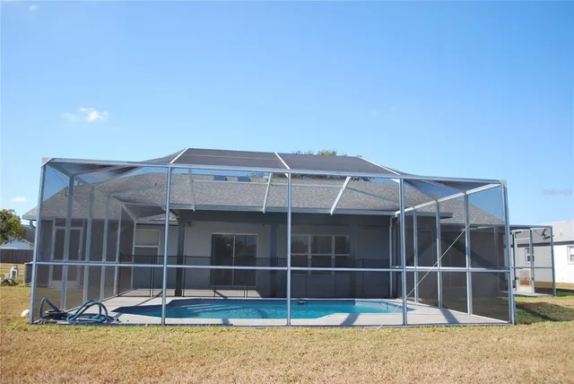 a view of a house with a backyard