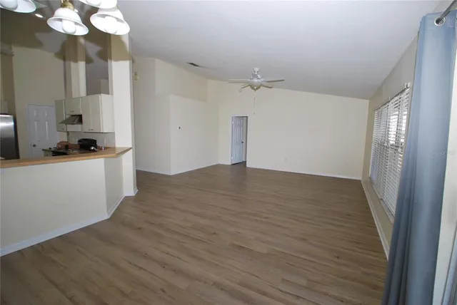 a view of a kitchen with a sink wooden cabinets and stainless steel appliances