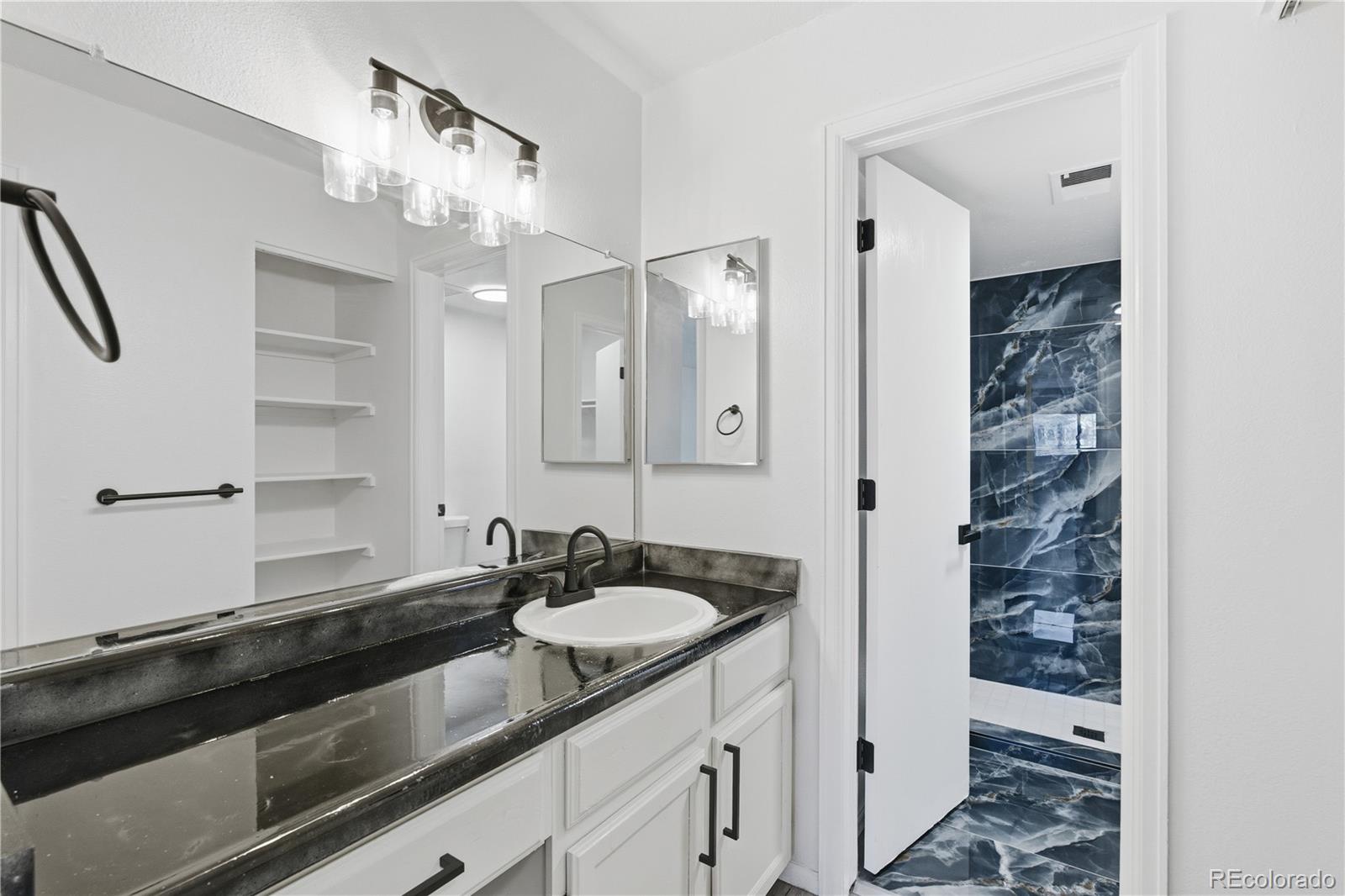 481 South Kalispell Way, Unit 306 Aurora, CO 80017 - Photo 12 of 43 a bathroom with a sink double vanity and a mirror