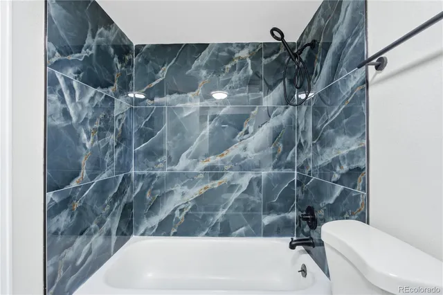 a bathroom with a bathtub and a toilet