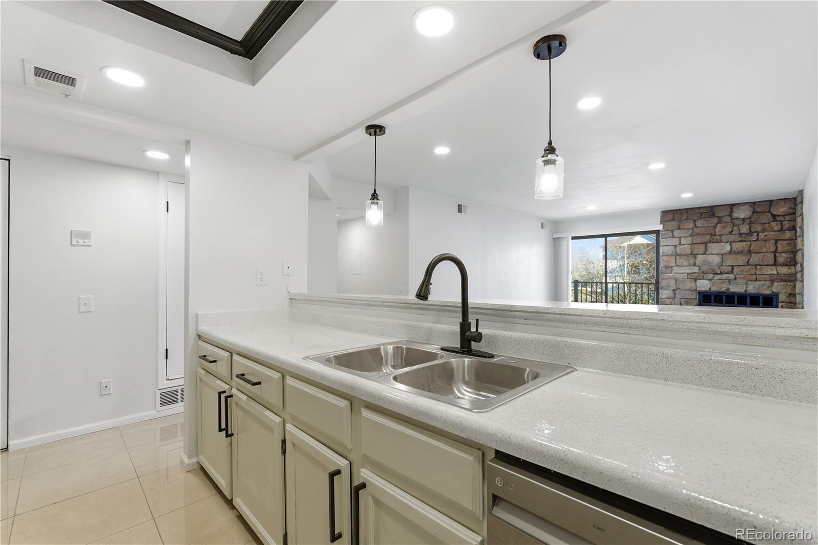 481 South Kalispell Way, Unit 306 Aurora, CO 80017 - Photo 20 of 43 a kitchen with a sink and outdoor space