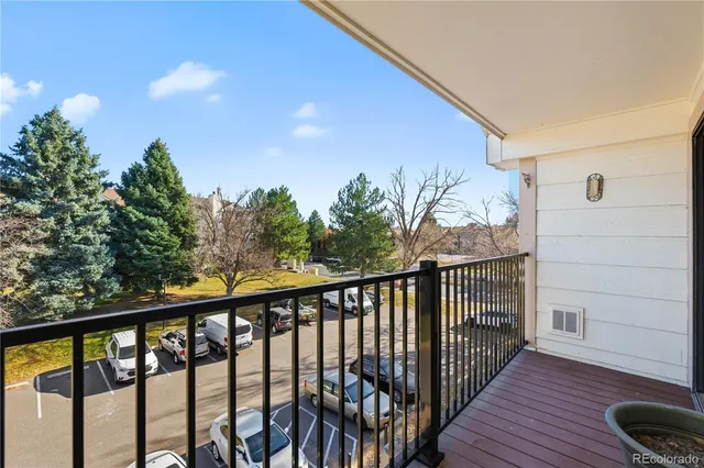 a balcony with wooden floor and fence