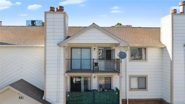 a view of a house with a yard and balcony
