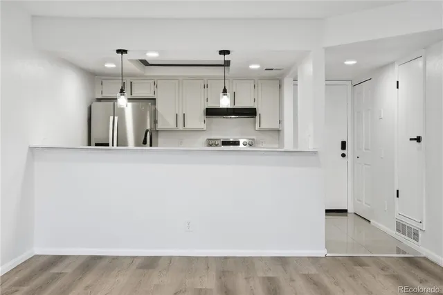 a kitchen with kitchen island a sink stainless steel appliances and cabinets