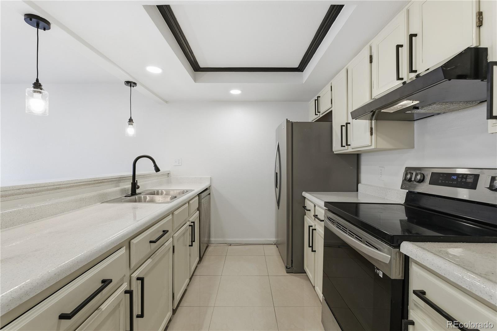 481 South Kalispell Way, Unit 306 Aurora, CO 80017 - Photo 8 of 43 a kitchen with stainless steel appliances granite countertop a sink and a stove