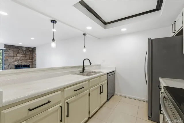 a kitchen with a sink and a refrigerator