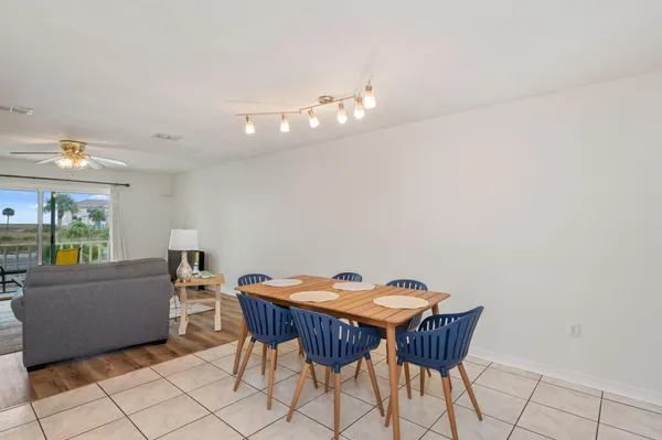 a view of a dining room with furniture and chandelier