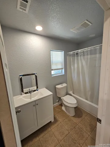 a bathroom with a toilet sink and shower