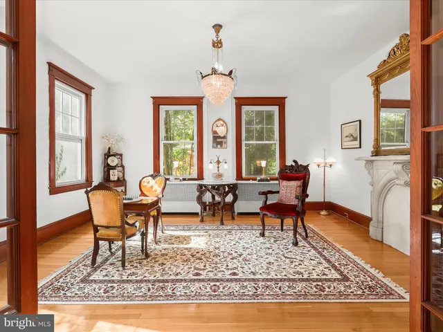 a living room with furniture a fireplace and a large window
