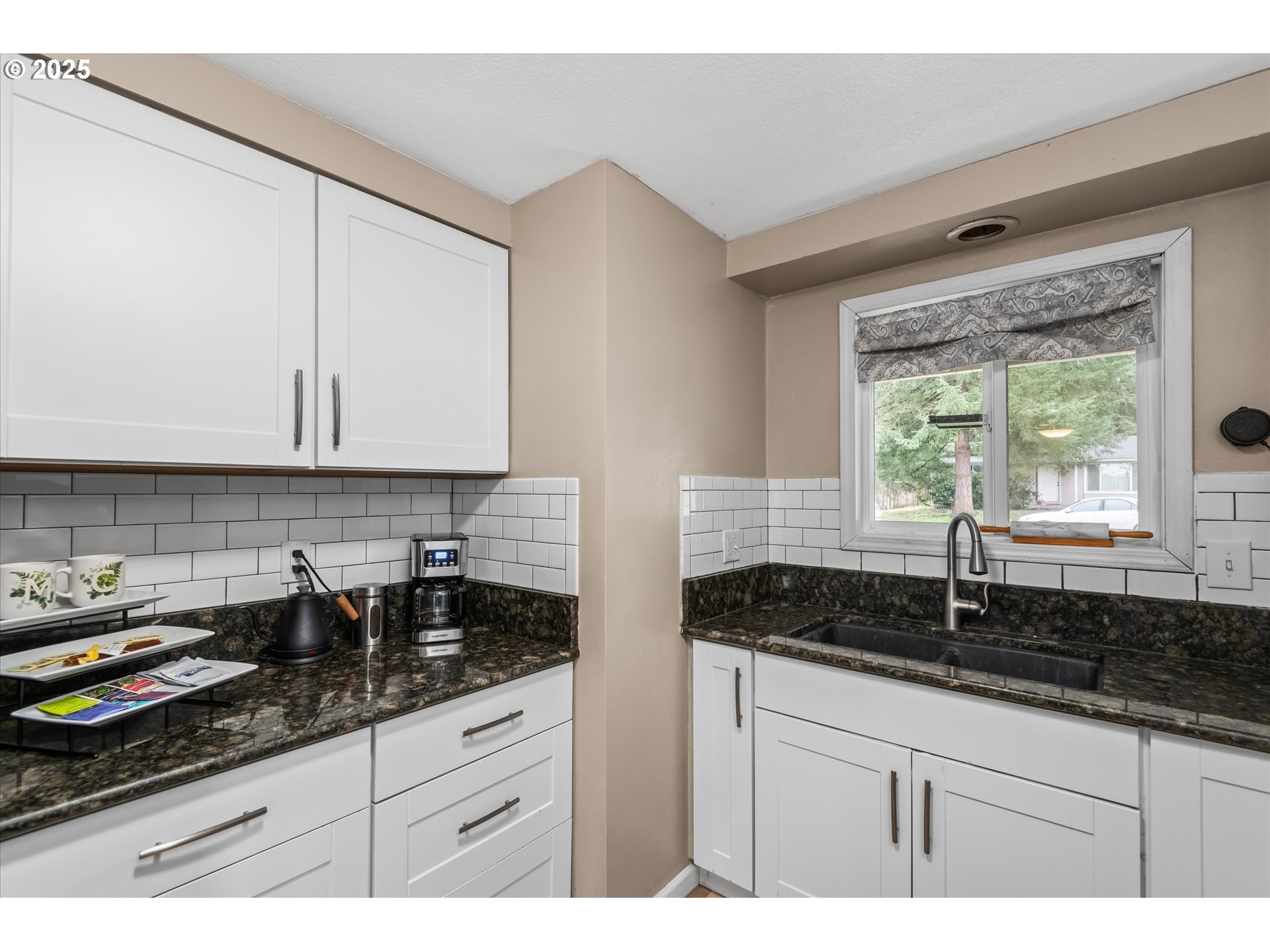 24795 Parkside Drive Veneta, OR 97487 - Photo 13 of 42 a kitchen with granite countertop white cabinets and a stove a sink