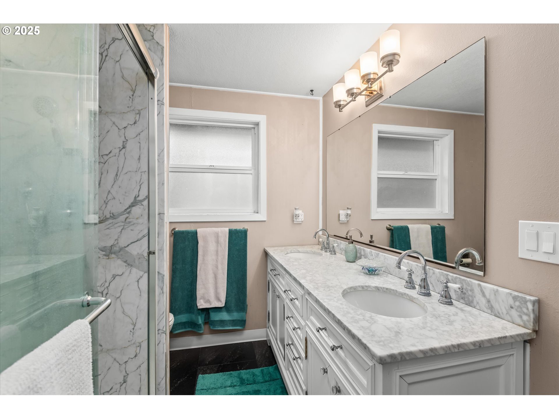 24795 Parkside Drive Veneta, OR 97487 - Photo 17 of 42 a bathroom with a granite countertop sink a shower a mirror and vanity