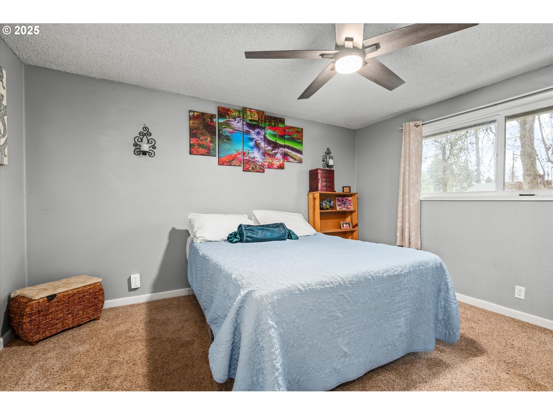 24795 Parkside Drive Veneta, OR 97487 - Photo 19 of 42 a bedroom with a bed and a chandelier