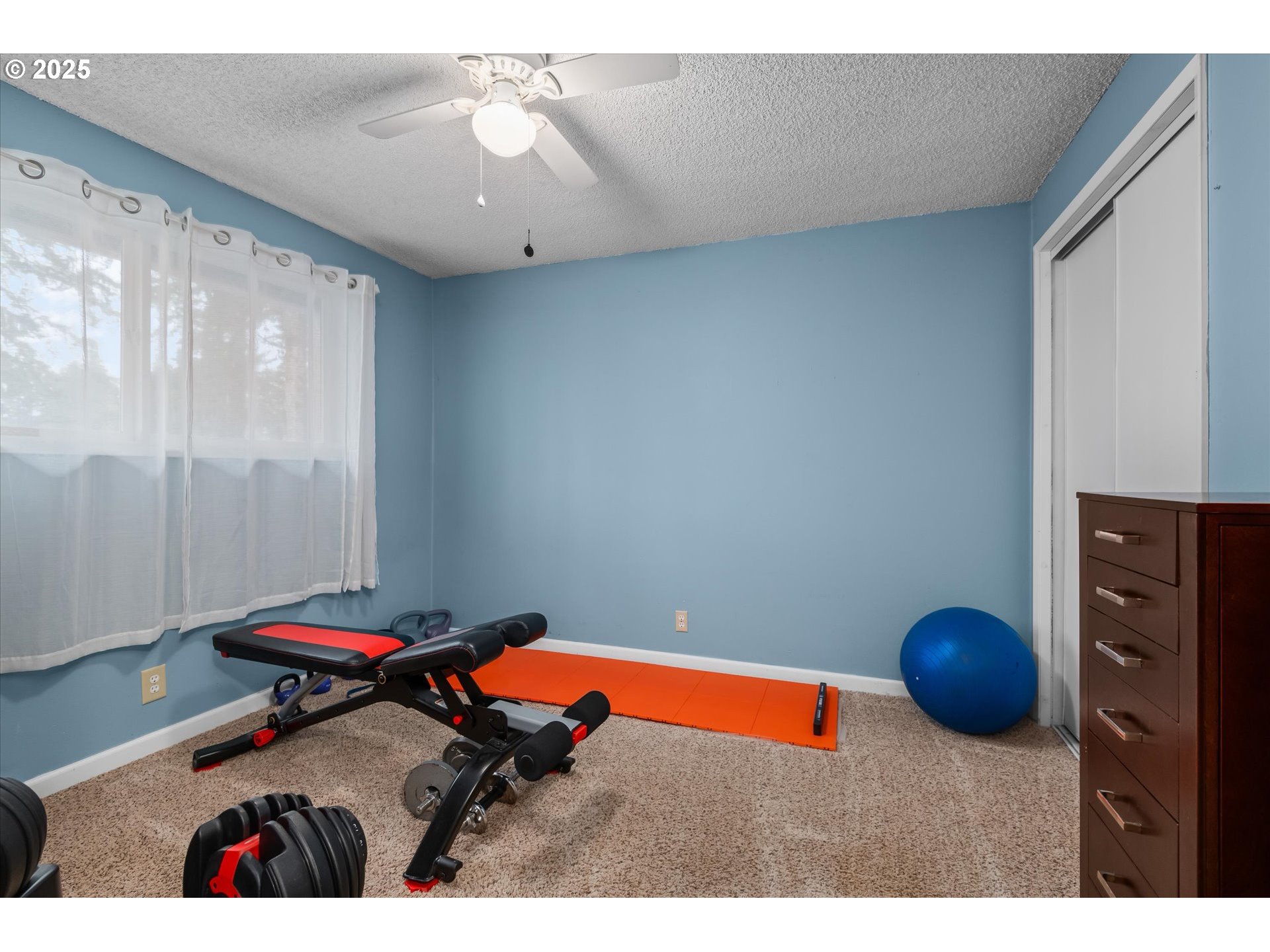 24795 Parkside Drive Veneta, OR 97487 - Photo 23 of 42 a bedroom with a bed and a chandelier