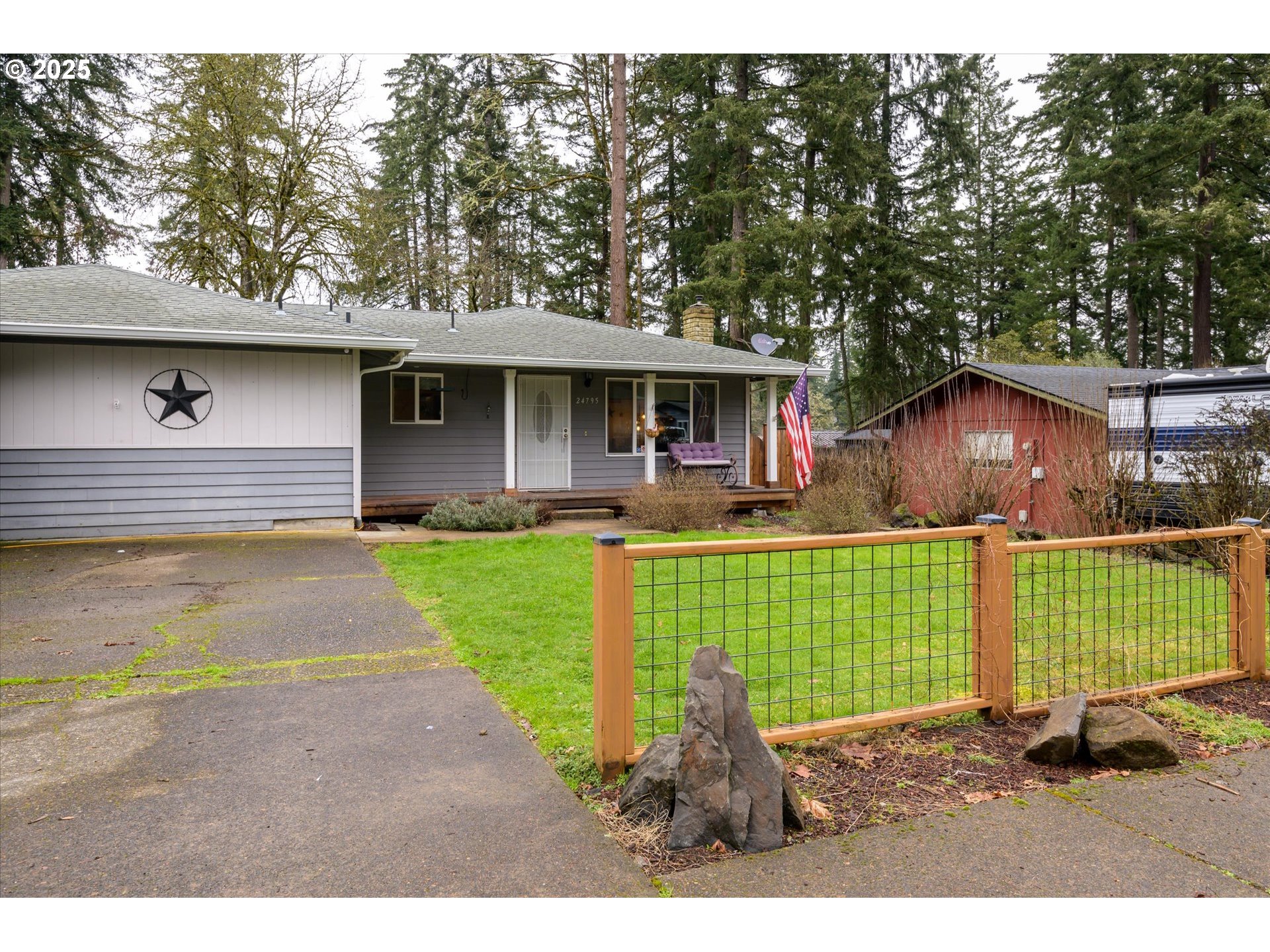24795 Parkside Drive Veneta, OR 97487 - Photo 3 of 42 a front view of a house with a garden and plants