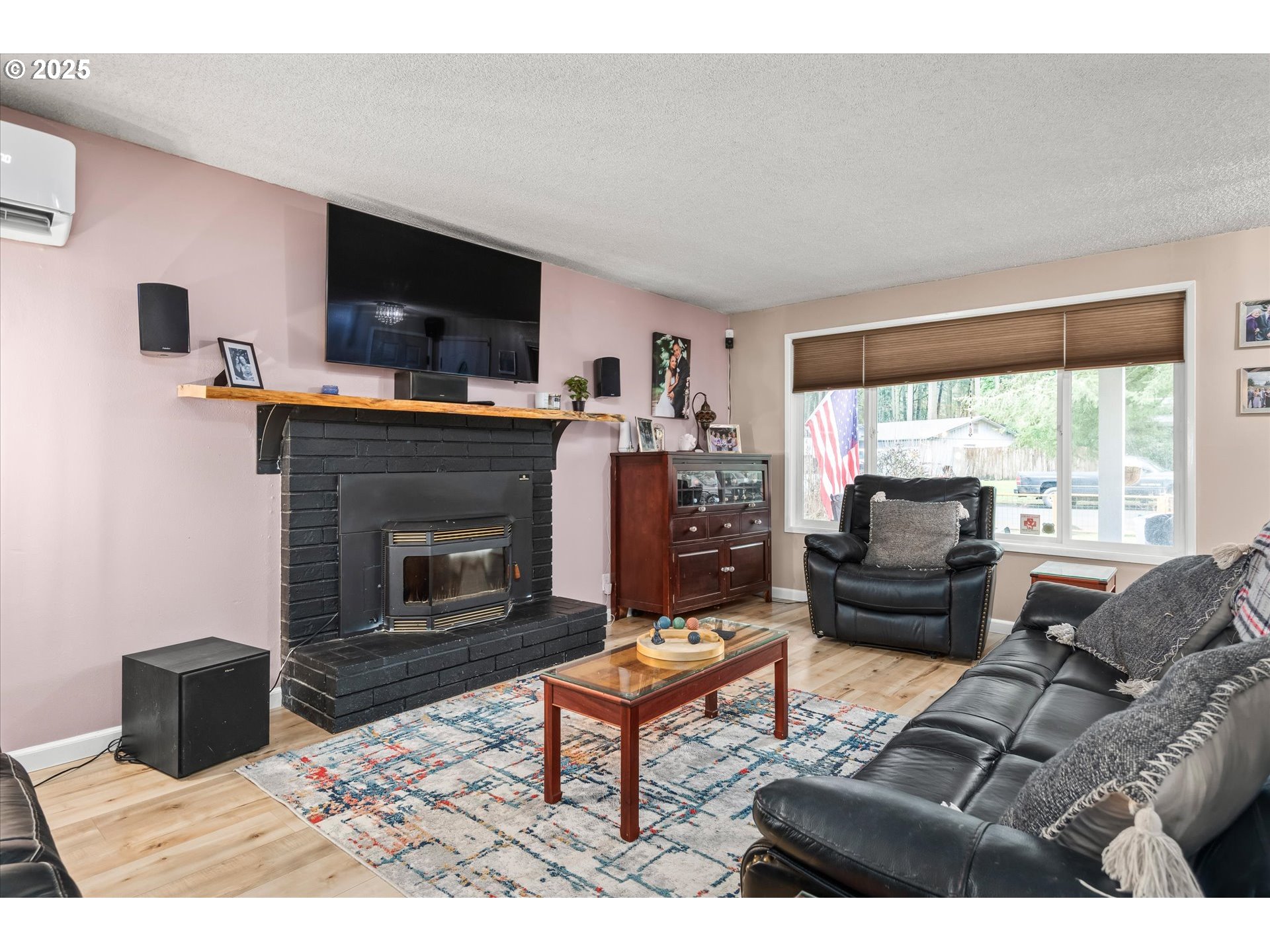 24795 Parkside Drive Veneta, OR 97487 - Photo 9 of 42 a living room with furniture a flat screen tv and a fireplace