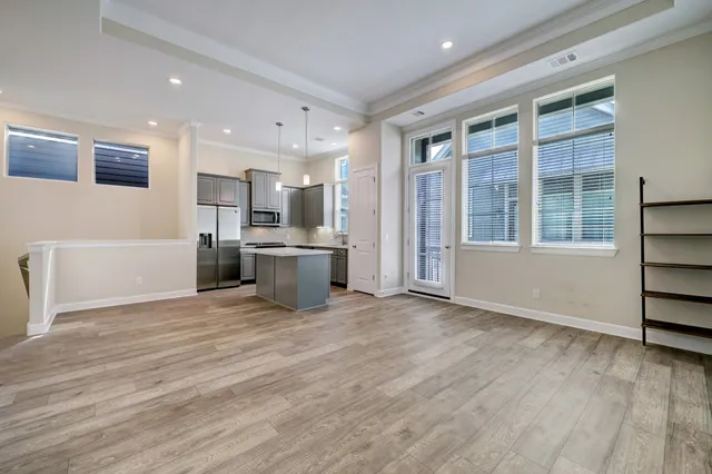 a view of kitchen with granite countertop cabinets and refrigerator