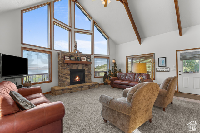 1340 Trapper Loop Garden City, UT 84028 - Photo 8 of 35 Carpeted living room with high vaulted ceiling, a fireplace, and beamed ceiling
