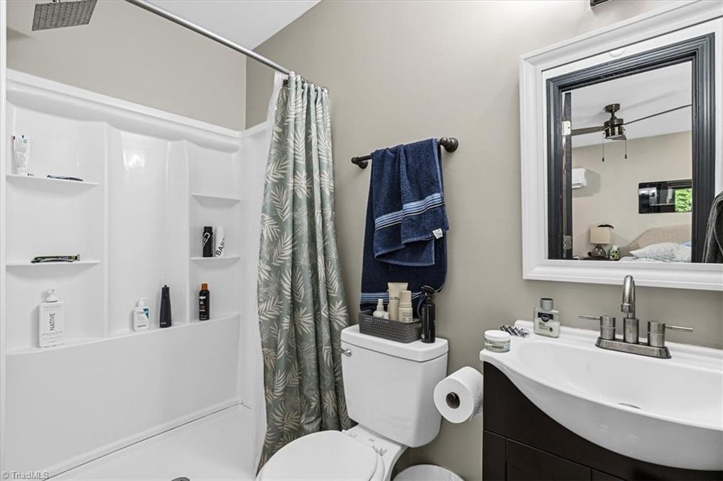 226 Friendly Avenue High Point, NC 27260 - Photo 19 of 38 The primary suite's private ensuite bathroom includes a vanity and sink. Please note this suite is unpermitted and full seller disclosures are available.