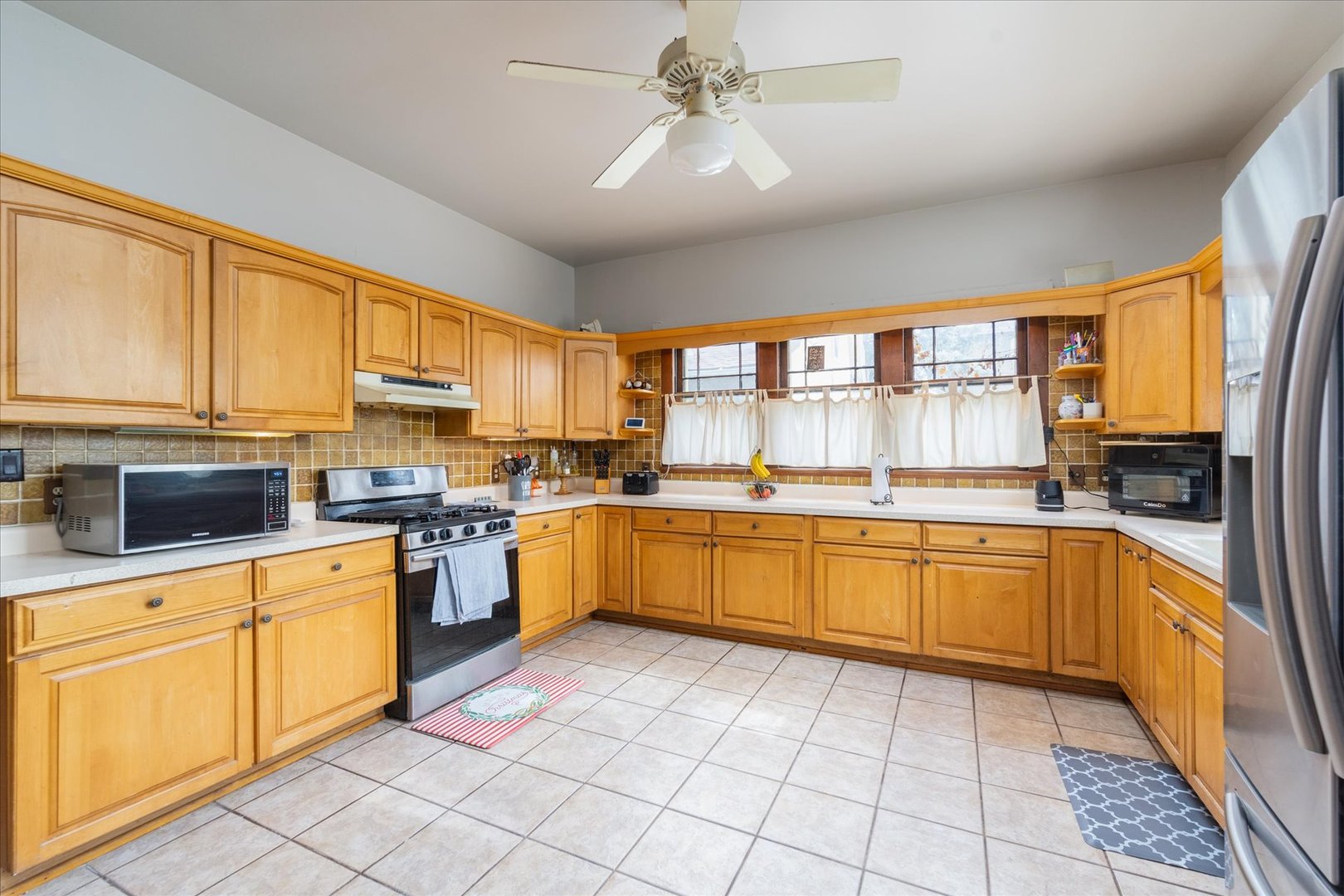532 7th Street LaSalle, IL 61301 - Photo 15 of 36 a large kitchen with a stove top oven a sink a counter space and cabinets