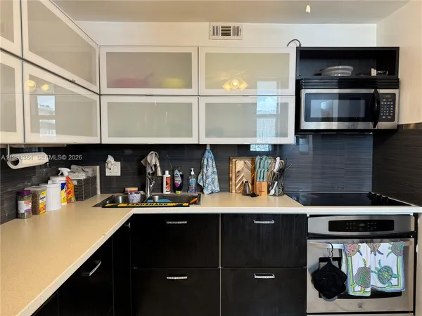 a kitchen with a sink and cabinets