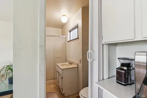 a bathroom with a toilet a sink and a mirror