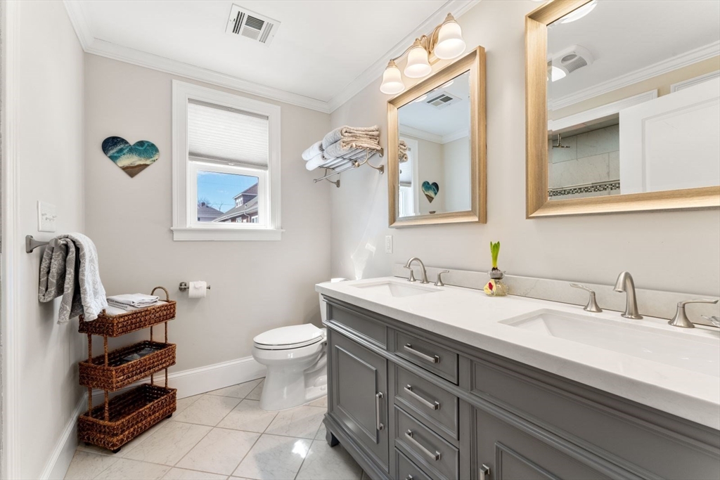 19 Damon Road Scituate, MA 02066 - Photo 18 of 33 a bathroom with a sink a toilet and a mirror