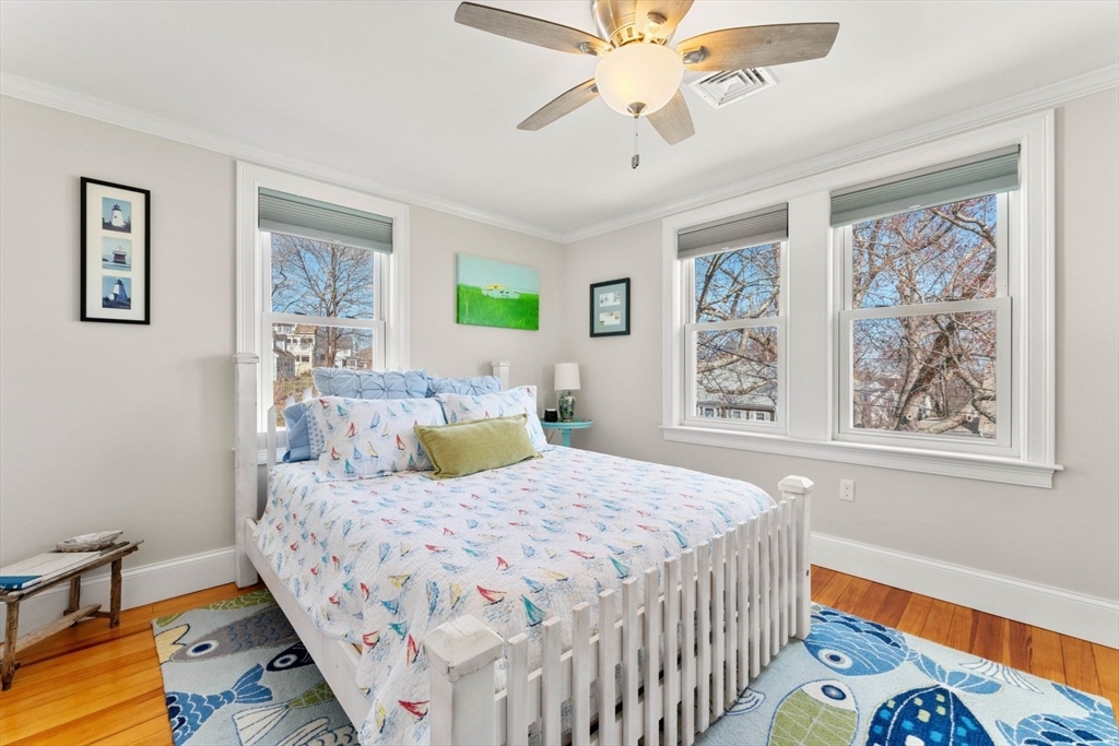 19 Damon Road Scituate, MA 02066 - Photo 20 of 33 a bedroom with a bed and a chandelier