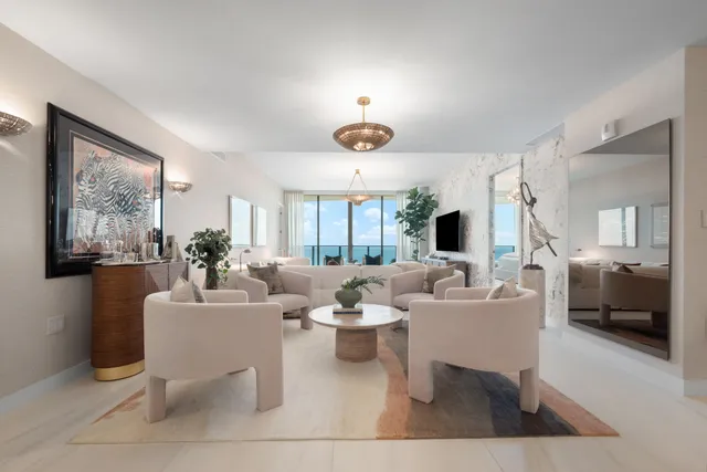 a living room with fireplace furniture and a large window