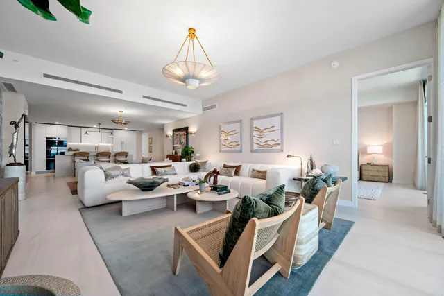 a living room with furniture and a chandelier