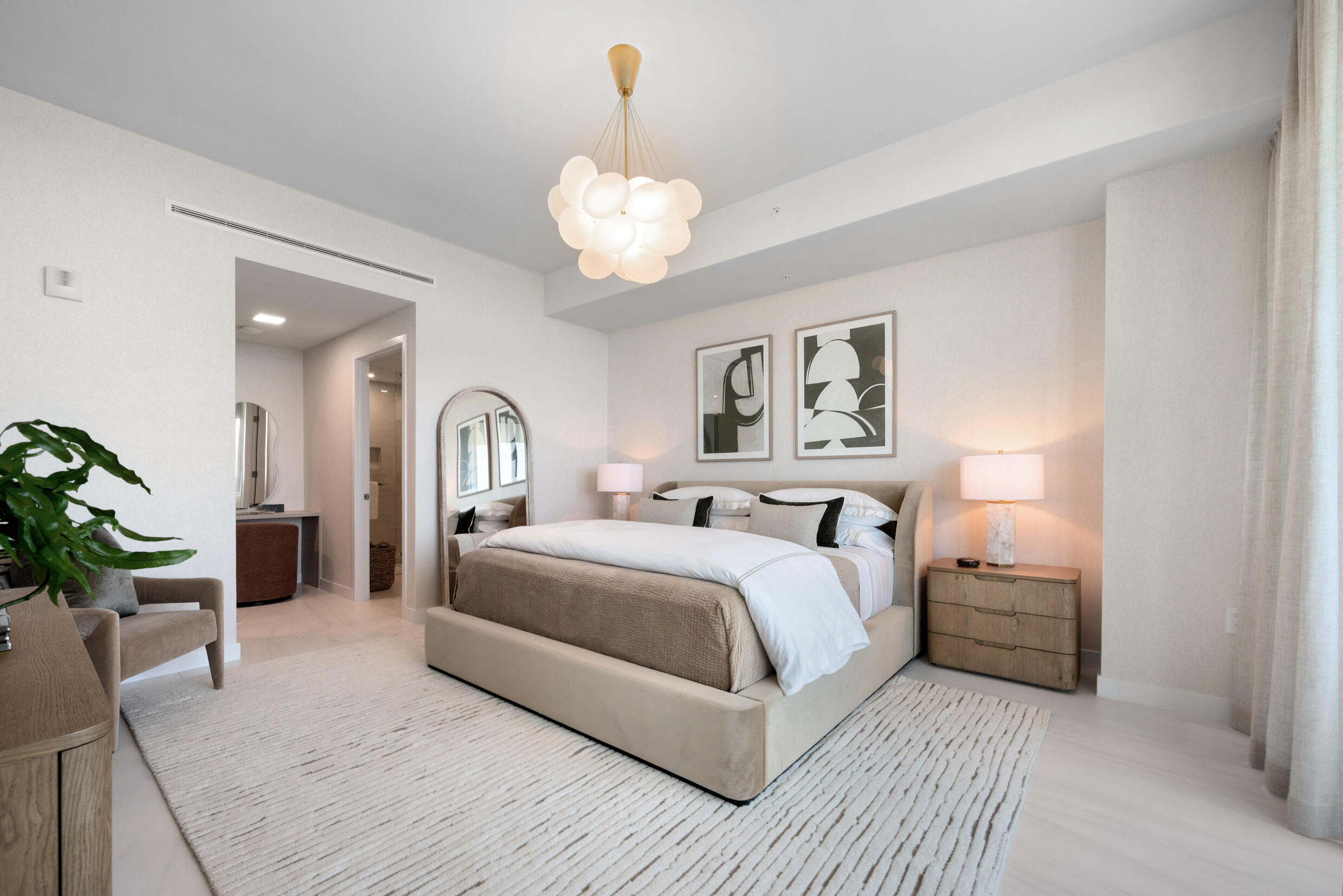 900 North Ocean Boulevard, Unit MPH02 Pompano Beach, FL 33062 - Photo 17 of 36 a bedroom with a bed and a chandelier