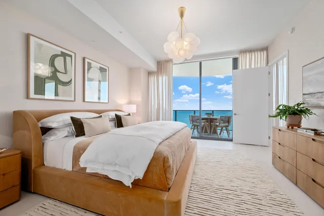 a living room with furniture potted plant and a chandelier