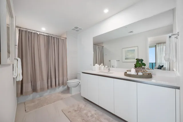 a bathroom with a double vanity sink and a mirror