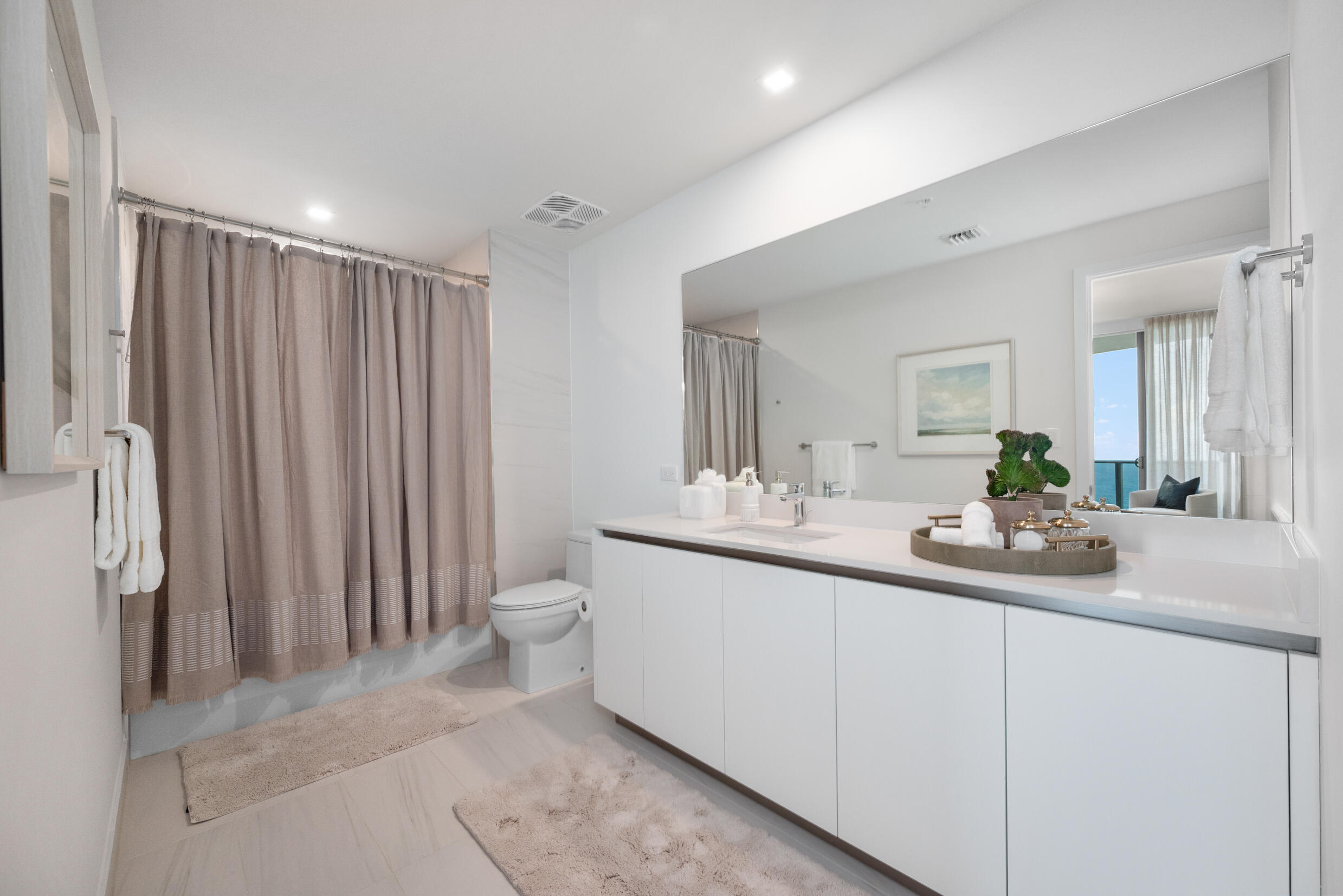 900 North Ocean Boulevard, Unit MPH02 Pompano Beach, FL 33062 - Photo 25 of 36 a bathroom with a double vanity sink and a mirror