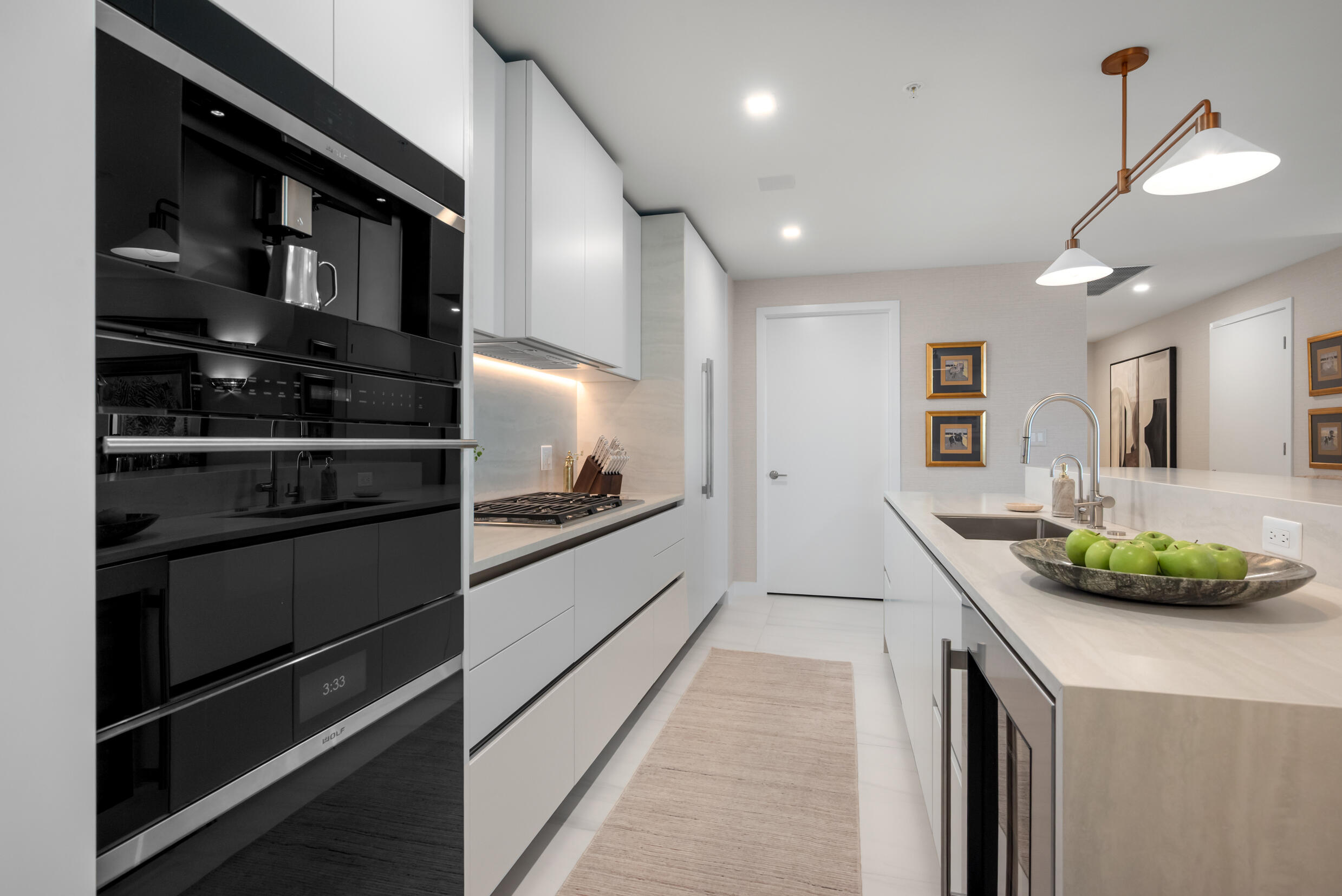 900 North Ocean Boulevard, Unit MPH02 Pompano Beach, FL 33062 - Photo 7 of 36 a kitchen with stainless steel appliances kitchen island granite countertop a stove and a refrigerator