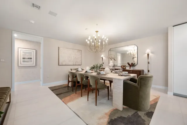 a view of a dining room with furniture and chandelier