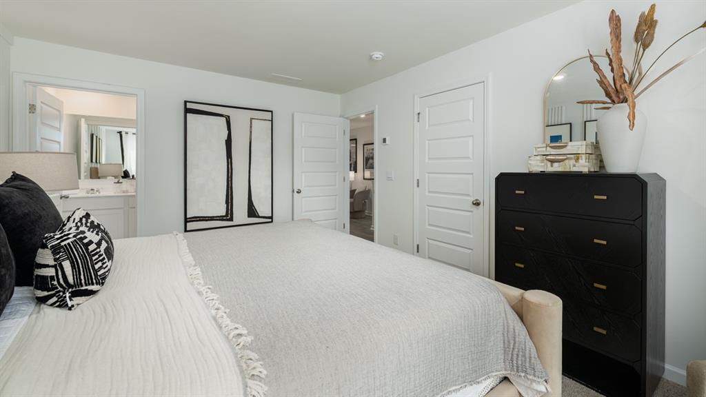 2836 Georgia Aster Way Northwest Atlanta, GA 30341 - Photo 17 of 28 a bedroom with a bed and a dresser