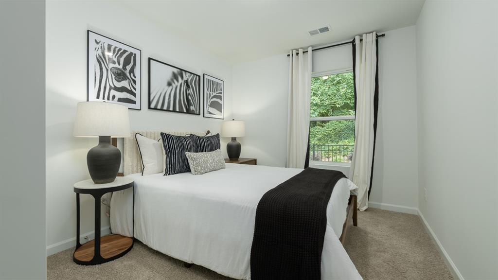 2836 Georgia Aster Way Northwest Atlanta, GA 30341 - Photo 24 of 28 a bedroom with a bed and window