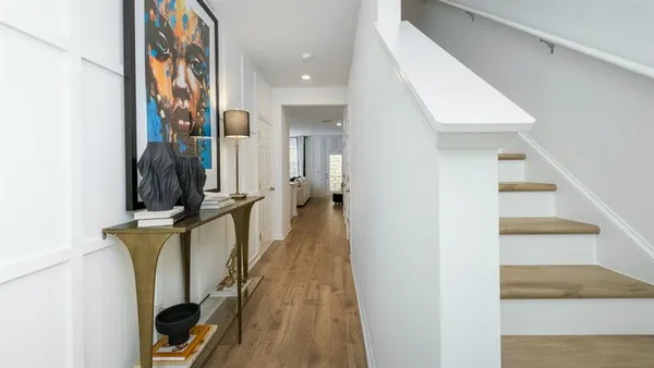 a kitchen with stainless steel appliances granite countertop a stove a sink a refrigerator and a refrigerator with wooden floor