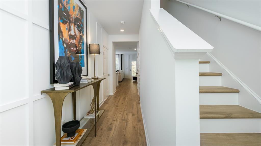 2836 Georgia Aster Way Northwest Atlanta, GA 30341 - Photo 3 of 28 a view of a hallway with wooden floor and staircase