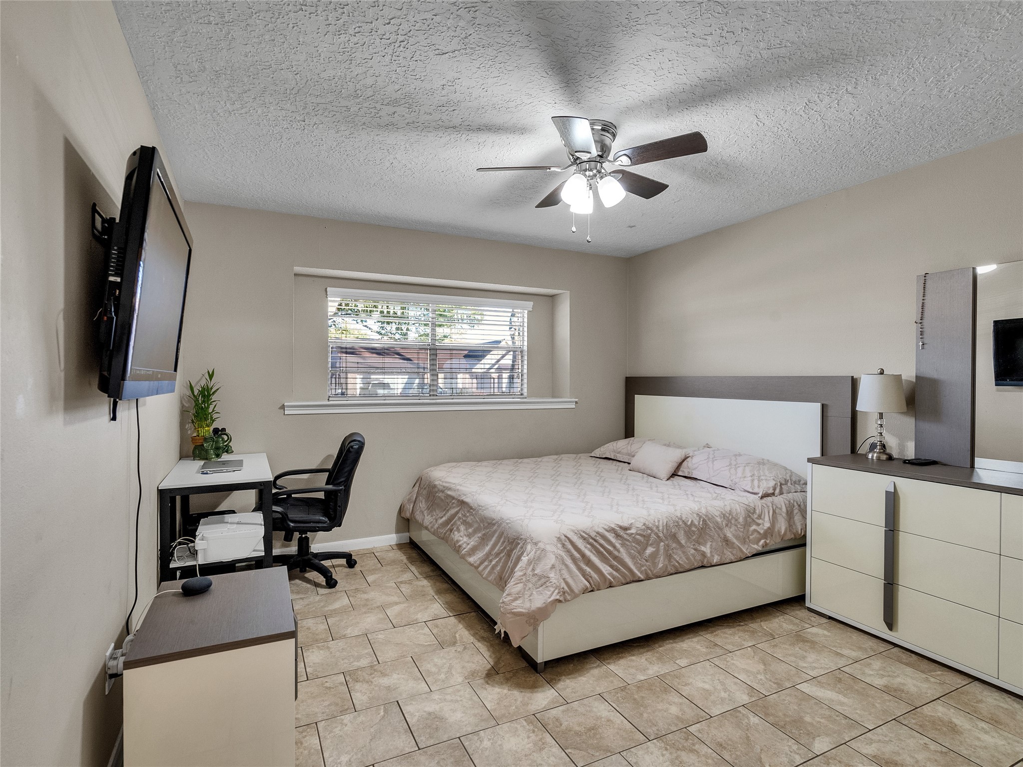 2201 Georgetown Street Katy, TX 77493 - Photo 16 of 20 a bedroom with a bed and a flat screen tv