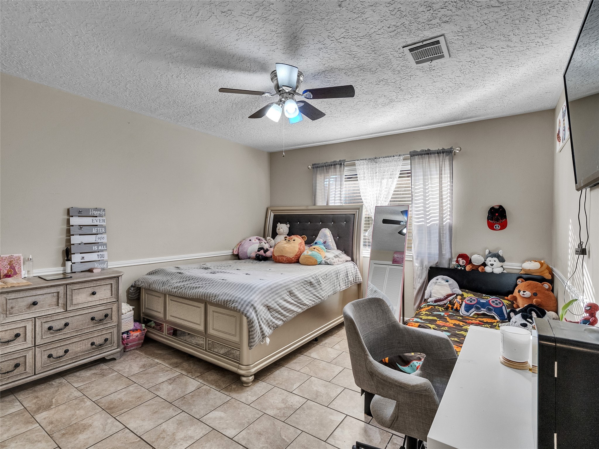 2201 Georgetown Street Katy, TX 77493 - Photo 17 of 20 a bedroom with a bed and a chandelier