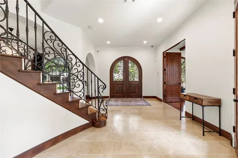 a view of entryway and hall with a bicycle