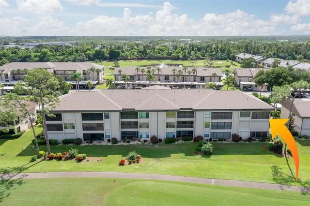 an aerial view of residential houses with outdoor space and swimming pool