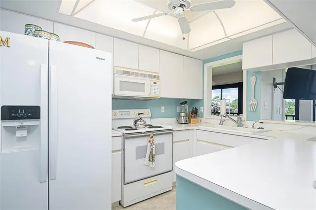 a kitchen with sink and cabinets