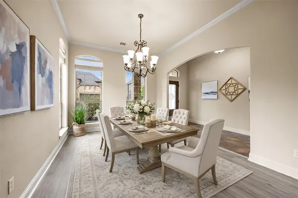 a living room with furniture a flat screen tv and a large window