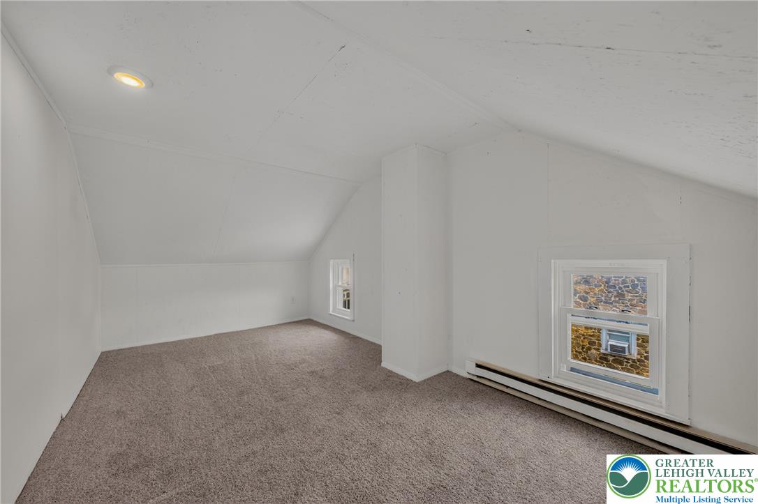 313 Main Street Slatington, PA 18080 - Photo 58 of 73 A cozy, sloped-ceiling room with soft carpeting offers an adaptable space.