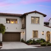 a front view of a house with plants